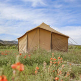 Altimus bell tent placed outdoors near flowers with a back view perfect for family camping and glamping