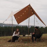 a couple enjoying the outdoors under the sunshade tarp